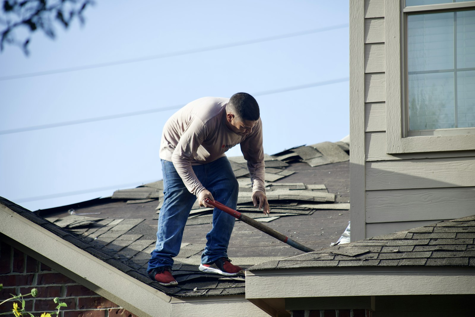 Contractor repairing a roof